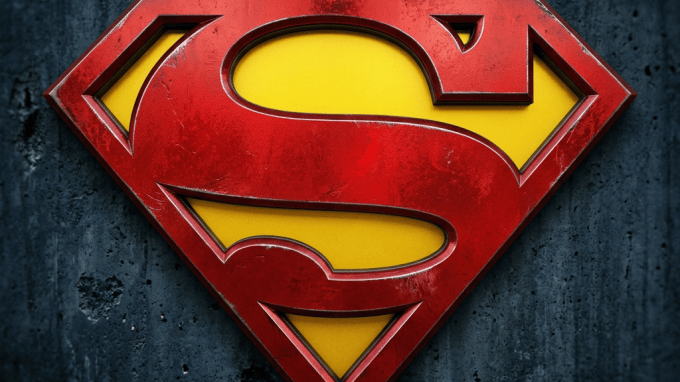 Weathered red and yellow Superman shield emblem on a dark wall